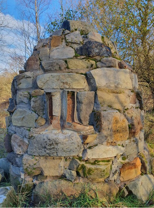 Cairn type structure with wellington boots